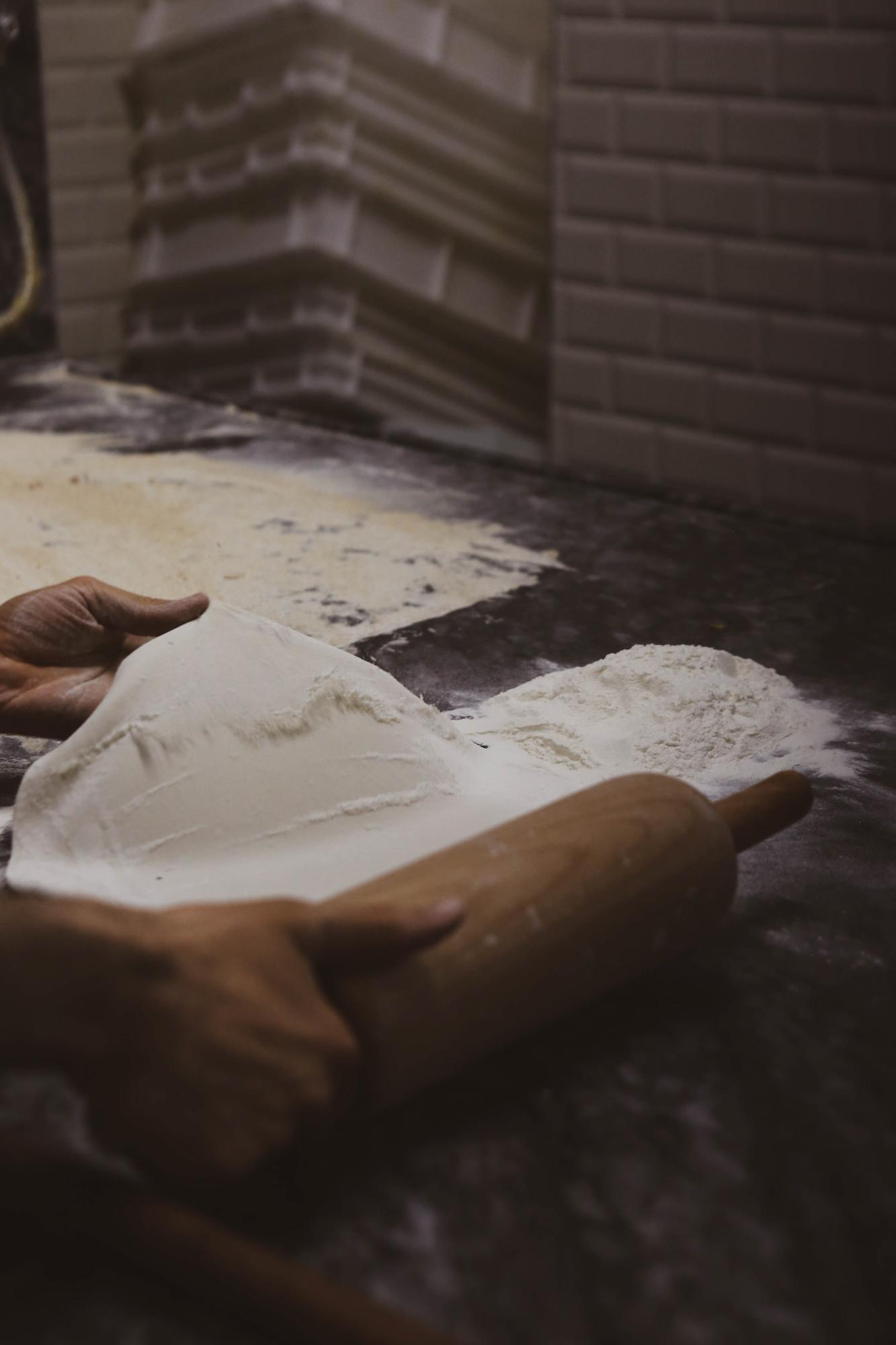 Close-up of hands preparing dough
